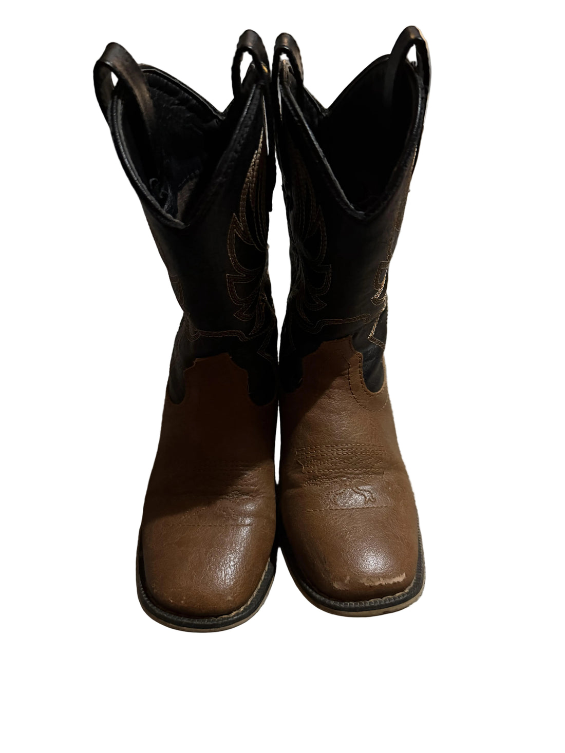 Pair of brown cowboy boots with intricate stitching.